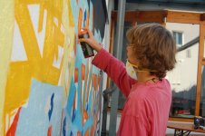 Kind sprayt Graffiti an Wand